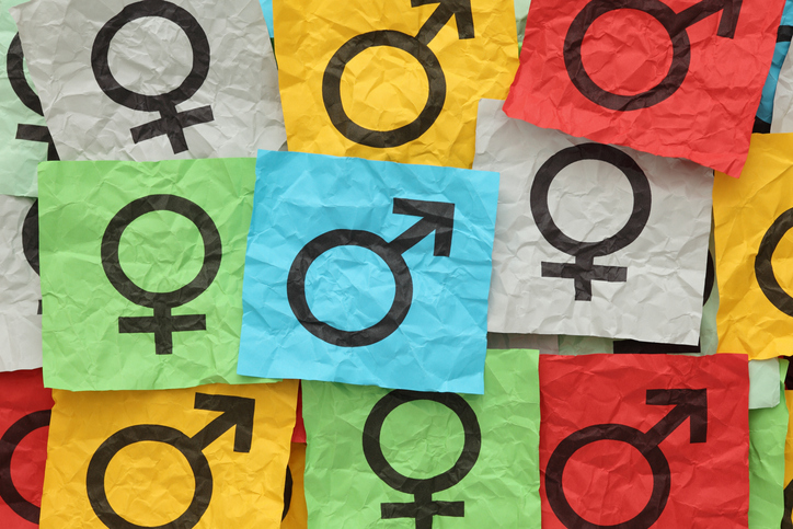 Close-up of gender symbols on colorful paper