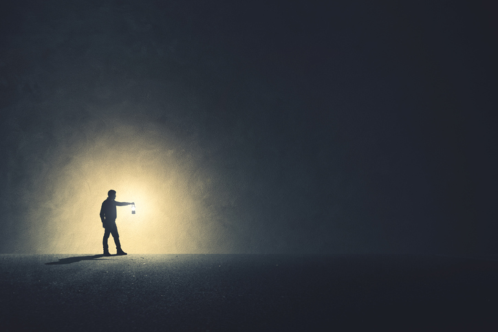 Man with lamp walking illuminating his path Man with lamp walking illuminating his path